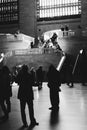 Grayscale vertical shot of busy people in Grand Central Terminal, New York City