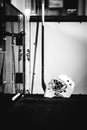 Grayscale vertical shot of hockey helmet and sticks