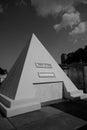 Grayscale vertical shot of Nicolas Cage's pyramid tomb at St. Louis Cemetery