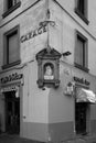 Grayscale vertical shot of an old building with religious icons in Florence, Italy