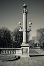 Grayscale vertical shot of a sone street light in Paris