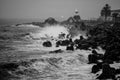 Grayscale view of big wave splash against stone formations at the coastline, Valparaiso