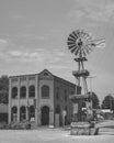 Grayscale view of a vintage wind wheel on the street of Blackwater, Missouri, USA