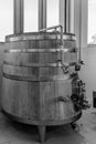 Grayscale of a wine-processing wooden barrel made of an oak tree in Cotnari vineyard, Romania