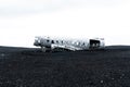 Grayscale of a wrecked airplane on a black sand beach in Iceland