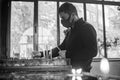 Grayscale of a young man praying and lighting candles in a church, Yerevan, Armenia Royalty Free Stock Photo