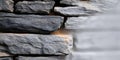 Graystone Stacked Wall as Architectural Texture Background with Rough Dark Rocks and Blocks Royalty Free Stock Photo