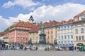 Graz, Austria-April 25, 2021: People relaxing in beautiful main square Hauptplatz, with famous Clock Tower on Schlossberg hill in