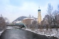 Graz, Austria-December 03, 2020: Mur river, Franciscan Church tower and famous clock tower in the background,Styria region,Austria