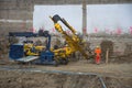 Graz/Austria - October 09, 2019: workers on construction site and a heavy duty machinery used for drilling holes in the ground Royalty Free Stock Photo