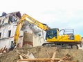 Graz/Austria - October 20, 2019: Yellow hydraulic excavator working on a old building demolition Royalty Free Stock Photo