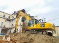 Graz/Austria - October 20, 2019: Yellow hydraulic excavator working on a old building demolition Royalty Free Stock Photo