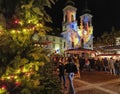 Graz, Austria-26.11.2022: People at a Christmas market with beautiful lights decorations and Mariahilfer church , at night, in the