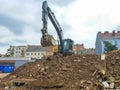 Graz, Austria-17.08.2020: Yellow industrial excavator working on demolition/construction site