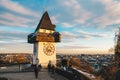 Graz city landmark Schlossberg park tower at sunset and city pan