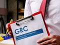 GRC Governance, risk management, and compliance document is in the hands. Royalty Free Stock Photo