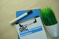 GRC - Governance, Risk Management, and Compliance write on a paperwork isolated on office desk Royalty Free Stock Photo