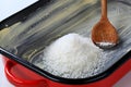 Greased baking tin with desiccated coconut