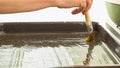 Greasing baking sheet with olive oil.