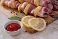 Greasy raw pork with skewered potatoes, barbecue with lemon and sauce on a wooden chopping Board close-up on the table Royalty Free Stock Photo