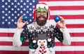 Great american Christmas. Happy santa on american flag background. Bearded american man with xmas tree balls. Uncle Sam