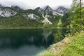Great azure alpine lake Vorderer Gosausee. Picturesque and gorgeous rain clouds Royalty Free Stock Photo