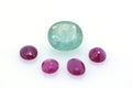 Great blue polished precious paraiba surrounded by red precious stones. Jewelry and gemology Royalty Free Stock Photo