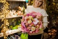Great bouquet of roses and other fresh flowers in the hands of woman Royalty Free Stock Photo