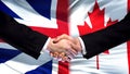 Great Britain and Canada handshake, international friendship, flag background