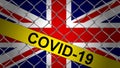 Great britain flag with yellow tape and chainlink fence