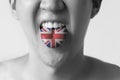 Great Britain flag painted in tongue of a man - indicating English language and British accent speaking in Black and White tone