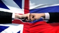 Great Britain vs Russia conflict, fists on flag background, diplomatic crisis Royalty Free Stock Photo