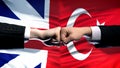 Great Britain vs Turkey conflict, fists on flag background, diplomatic crisis Royalty Free Stock Photo