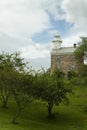 Great Captain Island Lighthouse As Sun Breaks Among Storm Clouds Approaching Royalty Free Stock Photo