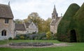 Great Chalfield Manor near Bradford on Avon, Wiltshire, UK, photographed from the garden with the church behind a yew tree. Royalty Free Stock Photo