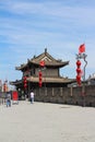 The great City wall of Xian city with a watchtower and red lanterns against a blue sky with clouds. Xian. China