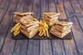 Great club sandwiches with lots of bacon-filled flats, fried eggs, lettuce, cheese, ketchup, ham, chicken fillets and a side of