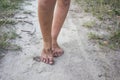 A great composition for the design with a little girl with dirty legs walk on sand