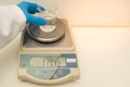 Great concept of research and development, hand weighing chemicals on precision scale Royalty Free Stock Photo