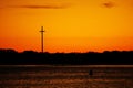 The Great Cross at sunset against a bright orange sky in St.Augustine, Florida.