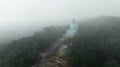 Great Daibutsu Buddha statue in morning mist on the top hill surround the forest in Wat Phra That Doi Phra Chan temple at Mae Tha
