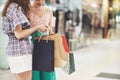 Great day for shopping. Two beautiful women look at the bag and boast about what they bought Royalty Free Stock Photo