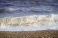 Strong waves hitting the pebbles on the beach