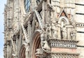 Great example of Italian architecture of the 14th century, facade of Duomo di Siena with sculptures and reliefs, Tuscany