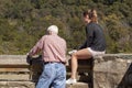 An elderly man and his teen daughter are looking at the great falls,