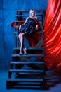 Great girl with white hair sitting on stairs and looking to the Royalty Free Stock Photo