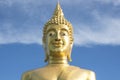 Great Golden Buddha statue in the temple with blue sky and white cloud