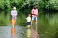 Great-grandfather and great-grandson. Grandson with father and grandfather fishing by lake. Happy grandfather, father Royalty Free Stock Photo
