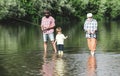 Great-grandfather and great-grandson. Grandson with father and grandfather fishing by lake. Happy grandfather, father Royalty Free Stock Photo
