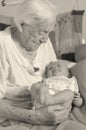 Great-grandmother holds in arms her great-grandson Royalty Free Stock Photo